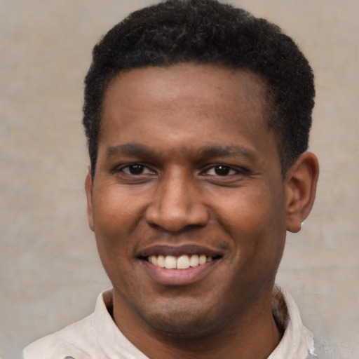 Joyful latino young-adult male with short  black hair and brown eyes