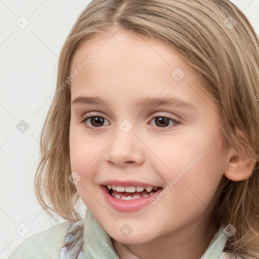 Joyful white child female with medium  brown hair and brown eyes