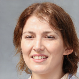 Joyful white young-adult female with medium  brown hair and blue eyes