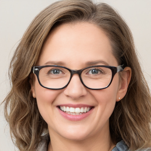 Joyful white adult female with medium  brown hair and blue eyes