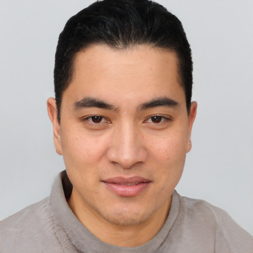 Joyful white young-adult male with short  black hair and brown eyes