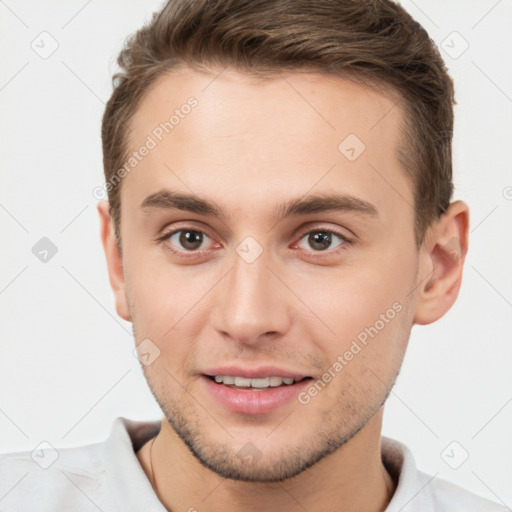 Joyful white young-adult male with short  brown hair and brown eyes