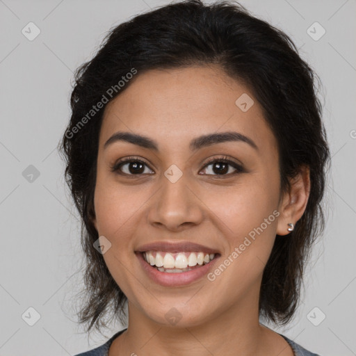 Joyful latino young-adult female with medium  brown hair and brown eyes