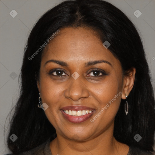 Joyful black young-adult female with long  brown hair and brown eyes