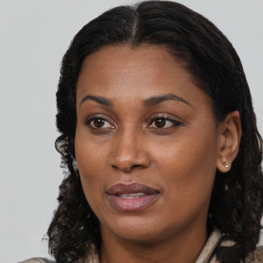 Joyful black young-adult female with medium  brown hair and brown eyes