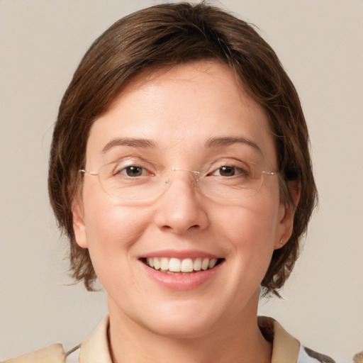 Joyful white adult female with medium  brown hair and grey eyes