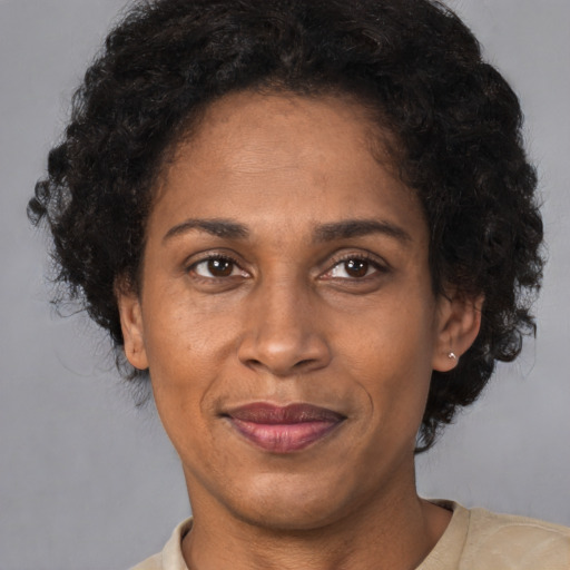 Joyful black adult female with short  brown hair and brown eyes