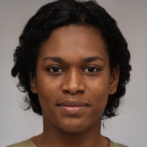 Joyful black young-adult female with medium  black hair and brown eyes