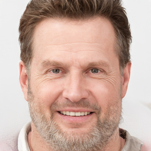 Joyful white adult male with short  brown hair and grey eyes