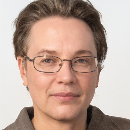 Joyful white adult female with short  brown hair and grey eyes