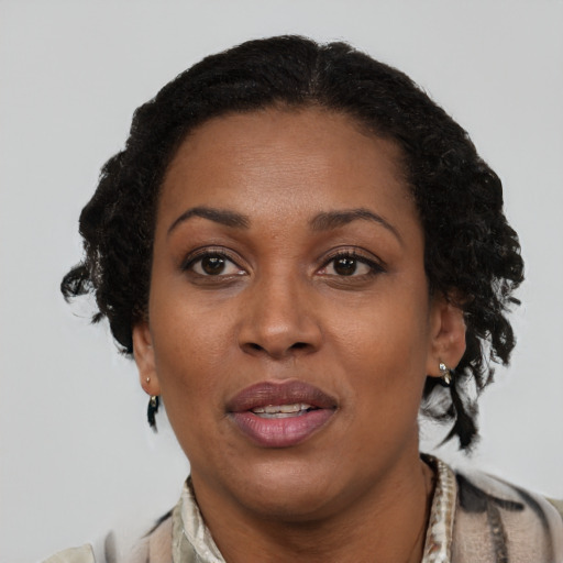 Joyful black adult female with short  brown hair and brown eyes