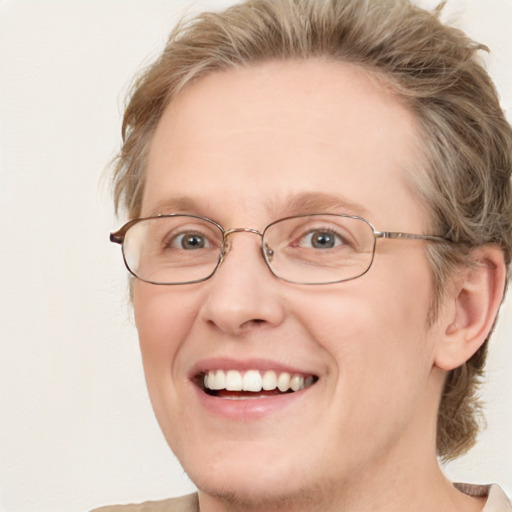 Joyful white adult female with medium  brown hair and blue eyes