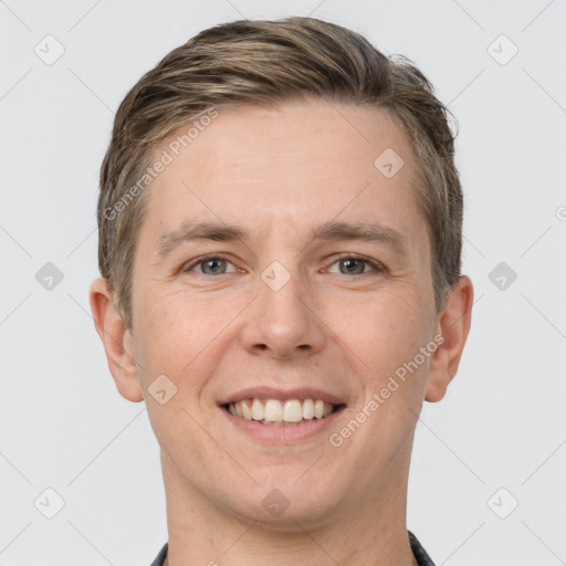 Joyful white adult male with short  brown hair and grey eyes