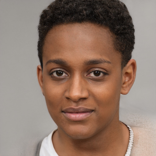 Joyful black young-adult female with short  brown hair and brown eyes