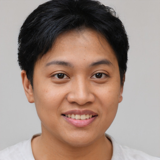 Joyful asian young-adult female with short  brown hair and brown eyes