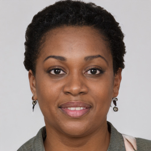 Joyful black adult female with short  brown hair and brown eyes