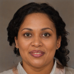 Joyful black adult female with medium  brown hair and brown eyes