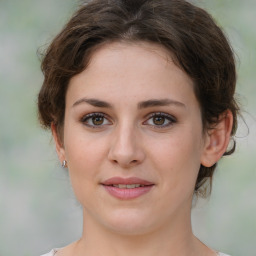 Joyful white young-adult female with medium  brown hair and green eyes