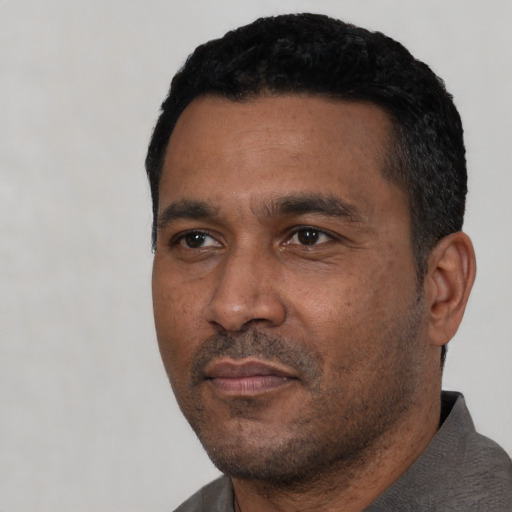 Neutral latino adult male with short  black hair and brown eyes