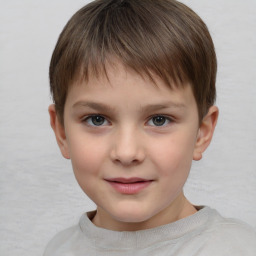 Joyful white child male with short  brown hair and brown eyes