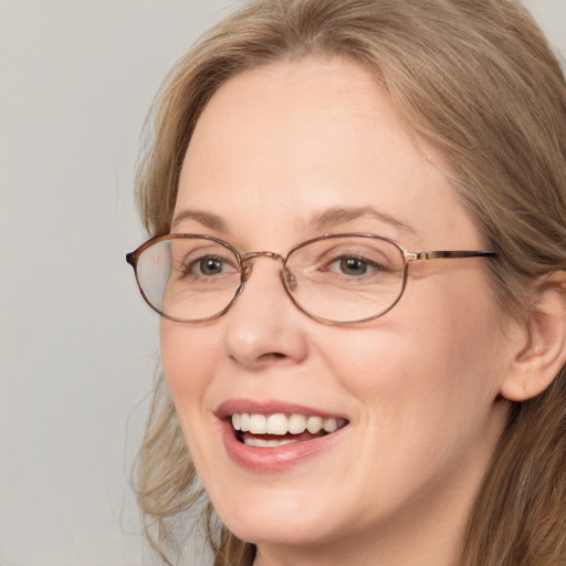 Joyful white adult female with long  brown hair and blue eyes