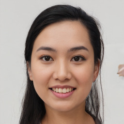 Joyful asian young-adult female with long  brown hair and brown eyes