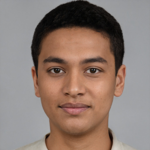 Joyful latino young-adult male with short  black hair and brown eyes