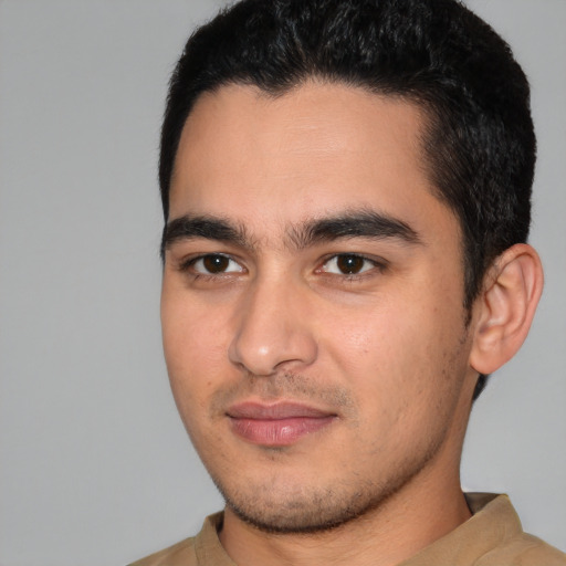 Joyful white young-adult male with short  black hair and brown eyes