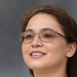 Joyful white adult female with long  brown hair and brown eyes