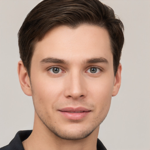 Joyful white young-adult male with short  brown hair and brown eyes