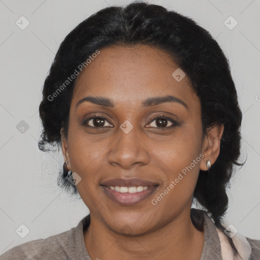 Joyful black young-adult female with long  black hair and brown eyes