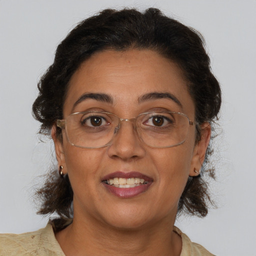 Joyful latino adult female with medium  brown hair and brown eyes