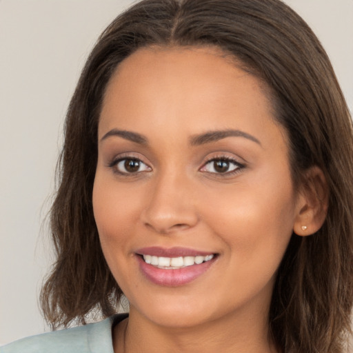 Joyful white young-adult female with long  brown hair and brown eyes