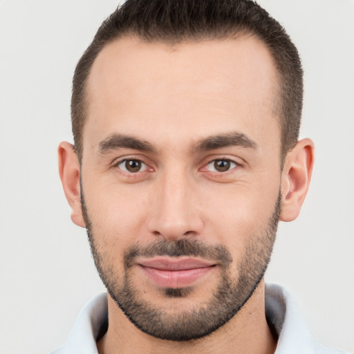 Joyful white young-adult male with short  brown hair and brown eyes