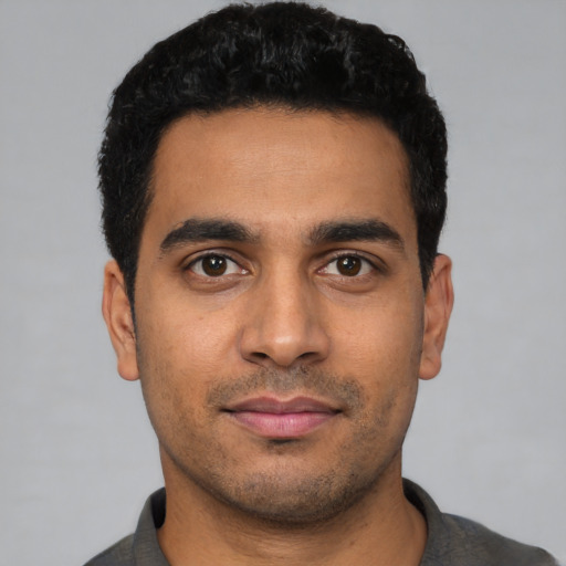 Neutral latino young-adult male with short  black hair and brown eyes