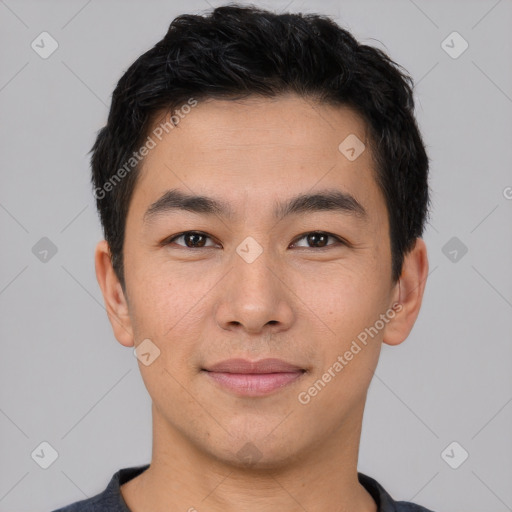 Joyful asian young-adult male with short  black hair and brown eyes