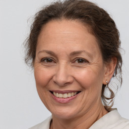 Joyful white middle-aged female with medium  brown hair and brown eyes