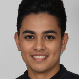 Joyful latino young-adult male with short  black hair and brown eyes