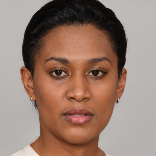 Joyful black young-adult female with short  brown hair and brown eyes