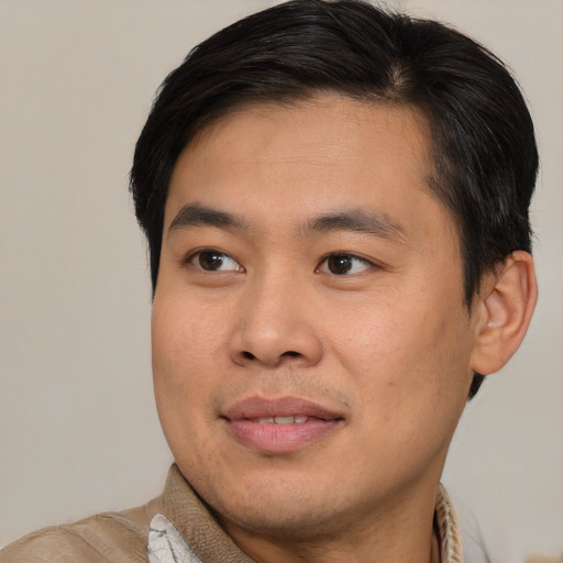 Joyful asian young-adult male with short  brown hair and brown eyes