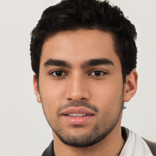 Joyful latino young-adult male with short  black hair and brown eyes