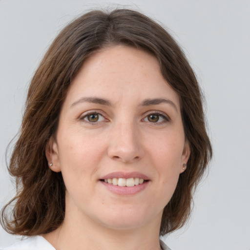 Joyful white young-adult female with medium  brown hair and green eyes