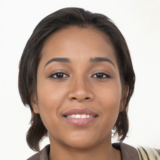 Joyful latino young-adult female with medium  brown hair and brown eyes