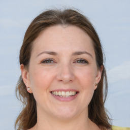 Joyful white adult female with long  brown hair and grey eyes