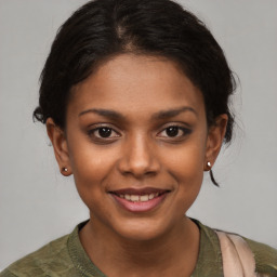 Joyful black young-adult female with medium  brown hair and brown eyes