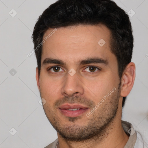 Joyful white young-adult male with short  black hair and brown eyes