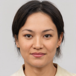 Joyful asian young-adult female with medium  brown hair and brown eyes