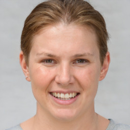 Joyful white young-adult female with short  brown hair and grey eyes