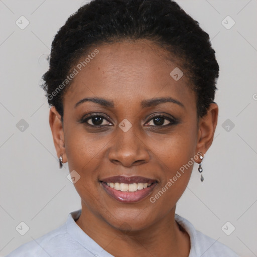 Joyful black young-adult female with short  black hair and brown eyes