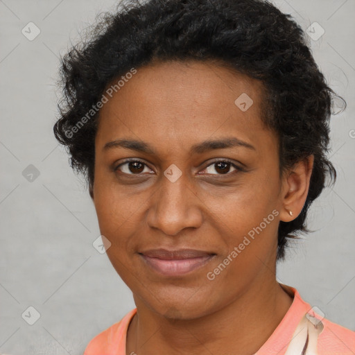 Joyful black adult female with short  brown hair and brown eyes